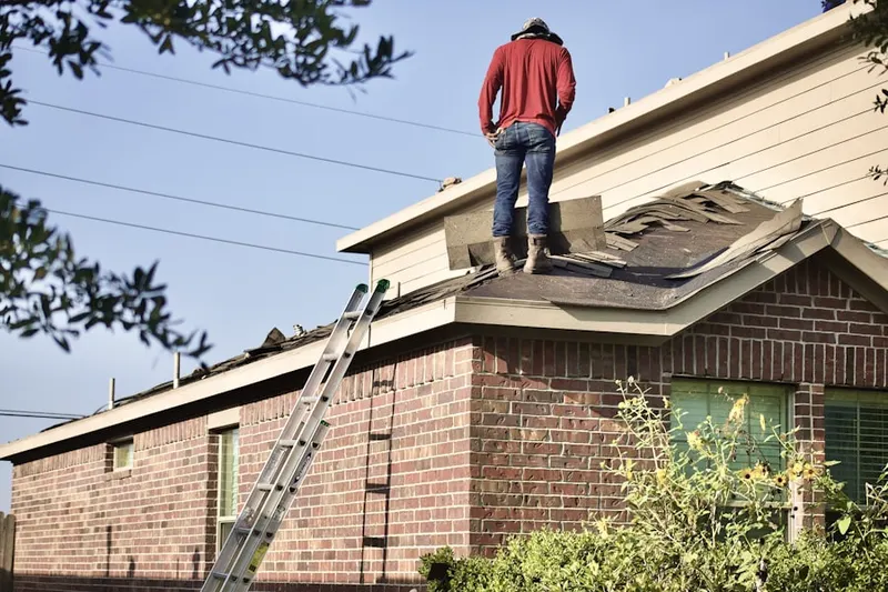 Professional roofer working on a residential roof in Port Isabel